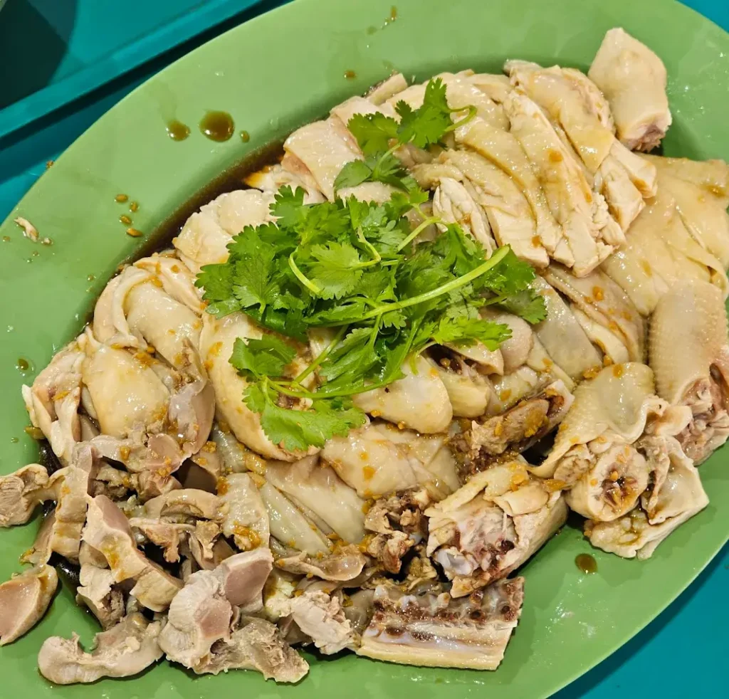Jurong East Food: 20 Spots Worth The Queue 12 Succulent boneless steamed chicken over glossy chicken rice with watery sharp chili sauce, a premier Jurong East food dish.