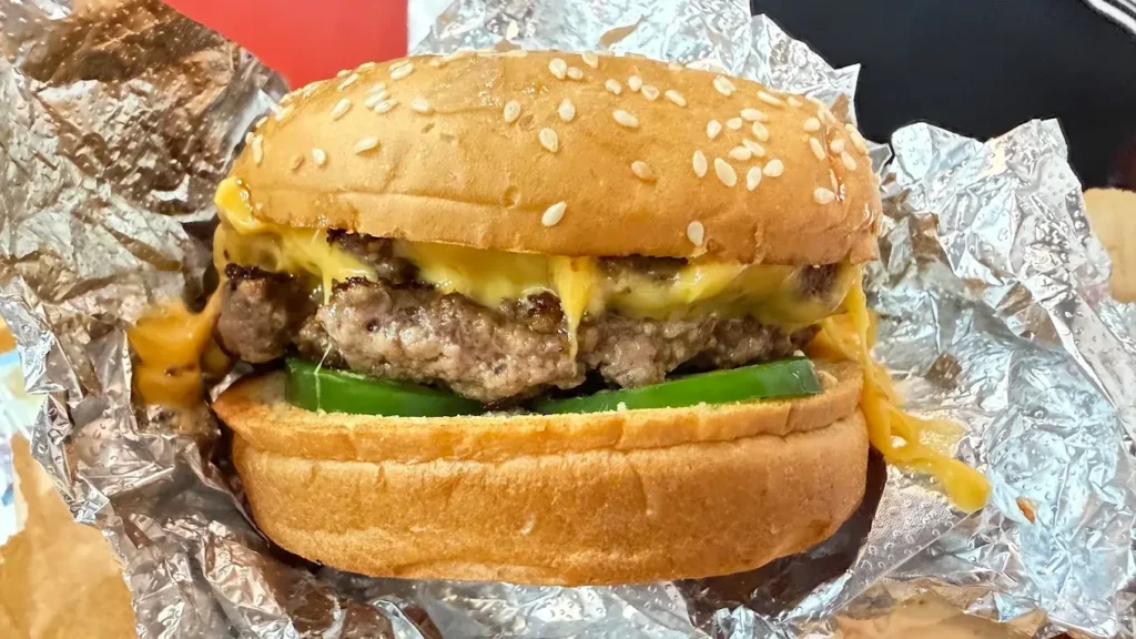 A juicy Bacon Cheeseburger from Five Guys, a popular choice for premium Plaza Singapura food.