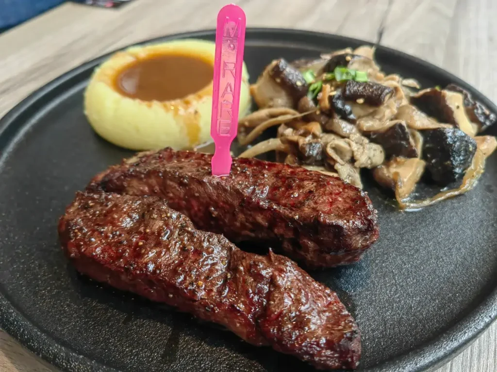 Perfectly seared Wagyu steak served with a free-flow salad bar at Bizen, a Plaza Singapura food gem.