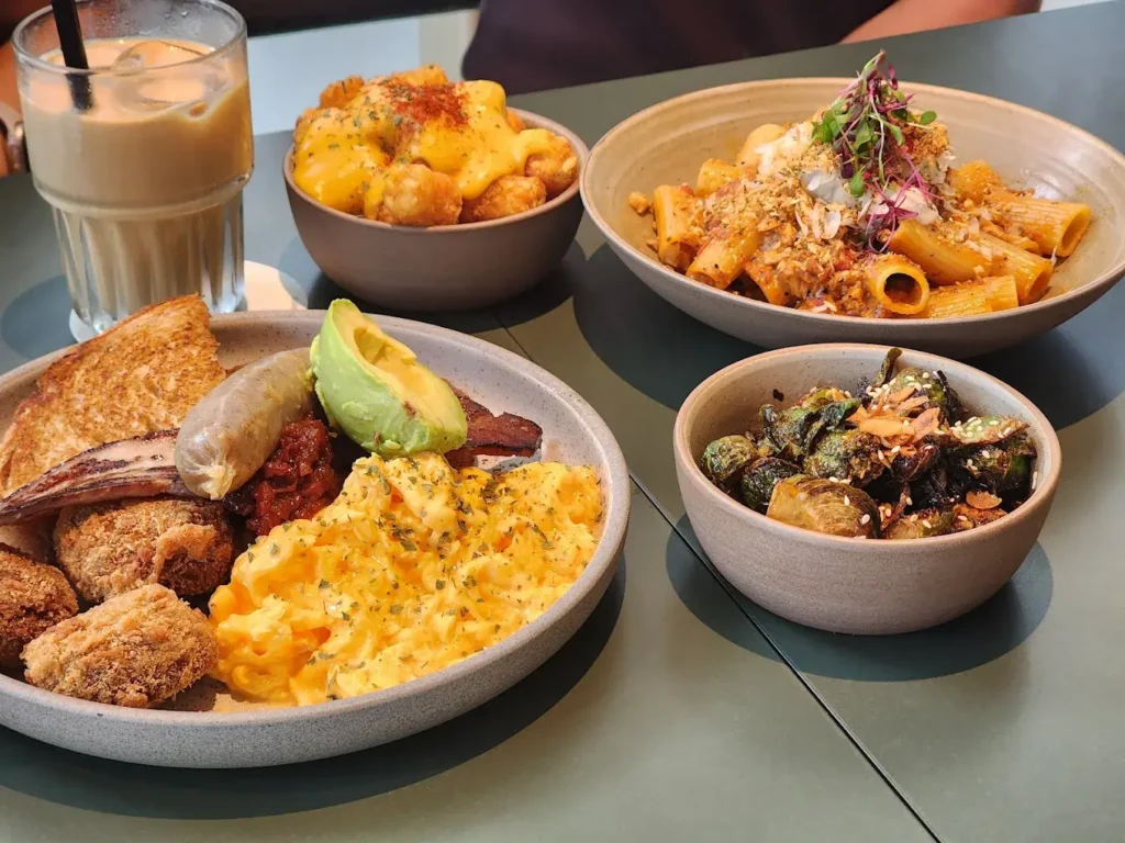 Honey paprika crispy wings and charred Brussels sprouts, showcasing the best Tampines Mall food at Lola's Cafe.