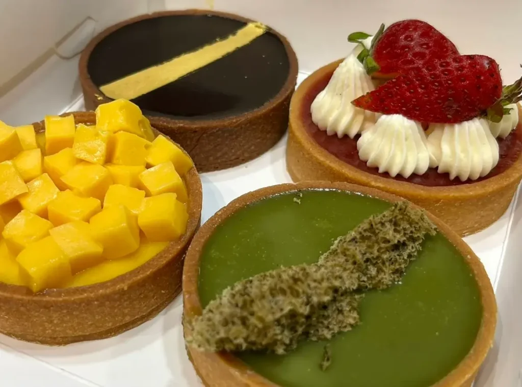 Box of assorted tarts including lemon meringue from Wunderfolks, a tasty Tampines Mall food dessert.