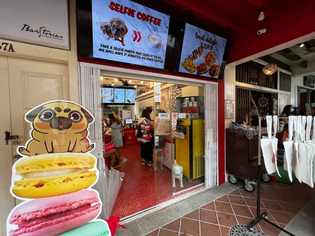 Best Dog Cafe Singapore: 26 Pet-Friendly Spots (2026) 2 A group of playful resident pugs greeting visitors at What The Pug, a dedicated dog cafe in Bugis.